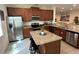 Bright kitchen boasting stainless steel appliances, granite countertops, and a central island at 7609 Brookhurst Ln, Kissimmee, FL 34747