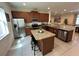Modern kitchen featuring stainless steel appliances, granite countertops, and an island at 7609 Brookhurst Ln, Kissimmee, FL 34747