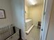 Bright laundry room with a washer, dryer, and convenient storage shelves at 7609 Brookhurst Ln, Kissimmee, FL 34747