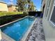 Stunning backyard pool and patio with a built-in spa and brick pavers at 7609 Brookhurst Ln, Kissimmee, FL 34747