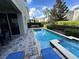 Beautiful backyard pool and patio area with lush landscaping and seating at 7609 Brookhurst Ln, Kissimmee, FL 34747