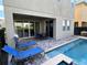 Backyard patio with a refreshing pool, lounge chairs, and outdoor dining area at 7609 Brookhurst Ln, Kissimmee, FL 34747