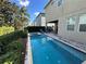 Inviting backyard pool area featuring a spa, patio, and lush landscaping at 7609 Brookhurst Ln, Kissimmee, FL 34747