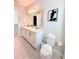 Bright bathroom featuring double sinks, a large mirror, Mickey Mouse wall art, and modern fixtures for a delightful aesthetic at 7719 Graben St, Kissimmee, FL 34747