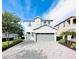 Charming two-story home with a well-manicured lawn, beautiful landscaping, and a spacious driveway at 7719 Graben St, Kissimmee, FL 34747