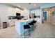 Spacious kitchen featuring a large island with seating, stainless steel appliances, and bright, neutral tones at 7719 Graben St, Kissimmee, FL 34747