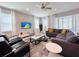 Cozy living room with a large sectional sofa, modern decor, and plenty of natural light from large windows at 7719 Graben St, Kissimmee, FL 34747
