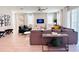 Well-lit living room featuring a comfortable seating arrangement, stylish decor, and large windows for natural light at 7719 Graben St, Kissimmee, FL 34747