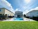 Inviting backyard pool with a hot tub, lounge chairs, a manicured lawn, and fencing, perfect for relaxation and entertainment at 7719 Graben St, Kissimmee, FL 34747