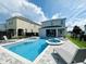 Inviting backyard pool with a hot tub, lounge chairs, a nearby house, and fencing, perfect for relaxation and entertainment at 7719 Graben St, Kissimmee, FL 34747
