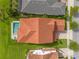 Aerial view of a home showcasing a red tile roof, a private pool, and a well-maintained backyard at 8025 Topsail Pl, Winter Garden, FL 34787