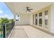 Large covered balcony with a fan, door to the interior, and black railing at 8025 Topsail Pl, Winter Garden, FL 34787