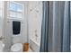 Clean bathroom featuring a toilet, towel rack, bathtub, and a blue shower curtain at 8025 Topsail Pl, Winter Garden, FL 34787