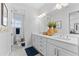 Bright bathroom with double vanity, and a toilet/shower room featuring neutral finishes at 8025 Topsail Pl, Winter Garden, FL 34787