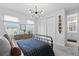 Bright bedroom with white walls, a window view, and a modern light fixture at 8025 Topsail Pl, Winter Garden, FL 34787