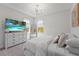 Well-lit bedroom with modern furnishings, a large window, and neutral color palette at 8025 Topsail Pl, Winter Garden, FL 34787