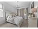 Bright bedroom with neutral tones, a white bed, and large windows at 8025 Topsail Pl, Winter Garden, FL 34787