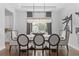 Formal dining room with large table, elegant chairs, and modern lighting fixture at 8025 Topsail Pl, Winter Garden, FL 34787