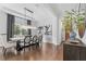 Open dining room with modern lighting and artwork, next to the home's entryway at 8025 Topsail Pl, Winter Garden, FL 34787