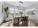 Bright dining room featuring a stylish chandelier and large windows offering pleasant views of the outdoors at 8025 Topsail Pl, Winter Garden, FL 34787