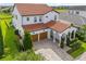 Aerial view showcases this beautiful white home with a terracotta roof and a spacious two car garage at 8025 Topsail Pl, Winter Garden, FL 34787