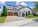 Stunning two-story home with a brick driveway, arched entryway, and a two-car garage at 8025 Topsail Pl, Winter Garden, FL 34787