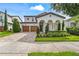 Charming home with manicured front yard, arched entry, and a two-car garage and brick paved driveway at 8025 Topsail Pl, Winter Garden, FL 34787
