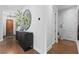 Inviting entryway hallway with dark wood floors, stylish decor, and access to other rooms at 8025 Topsail Pl, Winter Garden, FL 34787