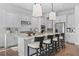 Bright kitchen with modern white cabinets, island seating, and stainless steel appliances at 8025 Topsail Pl, Winter Garden, FL 34787