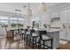 Bright kitchen and dining area with a central island and modern lighting at 8025 Topsail Pl, Winter Garden, FL 34787