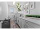 Well-lit laundry room with built-in cabinets, sink, washer, and dryer at 8025 Topsail Pl, Winter Garden, FL 34787