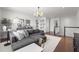 Cozy upstairs loft area with comfortable seating, stylish decor, and a staircase leading to lower level at 8025 Topsail Pl, Winter Garden, FL 34787
