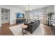 Inviting living room with a large TV, comfortable seating, and natural light from the windows at 8025 Topsail Pl, Winter Garden, FL 34787