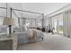 Spacious main bedroom with a canopy bed, natural light, and access to a private balcony at 8025 Topsail Pl, Winter Garden, FL 34787