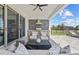 Outdoor kitchen with built-in grill, seating, and views of the backyard at 8025 Topsail Pl, Winter Garden, FL 34787