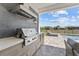 Stainless steel grill in an outdoor kitchen featuring modern cabinets and a view of the pool at 8025 Topsail Pl, Winter Garden, FL 34787