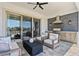 An outdoor kitchen featuring stainless steel appliances, a built-in grill, and comfortable seating at 8025 Topsail Pl, Winter Garden, FL 34787