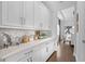 Walk-in pantry with white cabinetry, quartz countertops, and ample storage space at 8025 Topsail Pl, Winter Garden, FL 34787