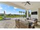 Relaxing outdoor patio area with comfortable seating, a view of the pool, and lush landscaping at 8025 Topsail Pl, Winter Garden, FL 34787