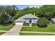 Beautiful home featuring a well-maintained lawn, mature trees, and a spacious driveway leading to a two-car garage at 824 Palm Cove Dr, Orlando, FL 32835