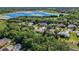 Aerial view of property location surrounded by lush trees in an established neighborhood near the lake at 824 Palm Cove Dr, Orlando, FL 32835