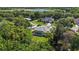 An aerial view showcasing the home's landscaped yard, screened lanai, and neighborhood lake at 824 Palm Cove Dr, Orlando, FL 32835