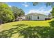 Expansive backyard featuring lush green lawn, mature trees, and ample space for outdoor activities at 824 Palm Cove Dr, Orlando, FL 32835