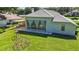 A vibrant backyard features a covered outdoor kitchen and playset, perfect for Gathering fun at 824 Palm Cove Dr, Orlando, FL 32835