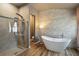 Bright bathroom features freestanding tub, accent wall, and glass enclosed shower at 824 Palm Cove Dr, Orlando, FL 32835