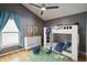 Cozy bedroom features bunkbeds, window and soft blue accent color at 824 Palm Cove Dr, Orlando, FL 32835