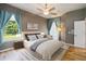 Comfortable bedroom features a ceiling fan, hardwood floors, and bright natural light at 824 Palm Cove Dr, Orlando, FL 32835
