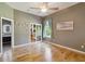 Bright bedroom featuring hardwood floors, closet, and ensuite bathroom with lighted vanity mirrors at 824 Palm Cove Dr, Orlando, FL 32835