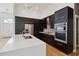 Modern kitchen with stainless steel appliances, a large island, and sleek, dark wood cabinets at 824 Palm Cove Dr, Orlando, FL 32835