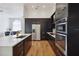 Sleek kitchen featuring an island, stainless appliances, and dark wood cabinets at 824 Palm Cove Dr, Orlando, FL 32835